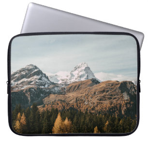 GREEN TREES NEAR SNOW COVERED MOUNTAIN DURING DAYT LAPTOP SLEEVE