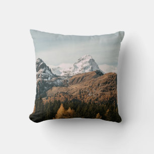 GREEN TREES NEAR SNOW COVERED MOUNTAIN DURING DAYT THROW PILLOW