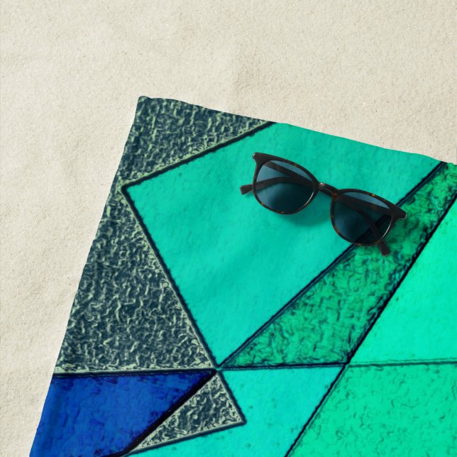 Green triangular cutouts on blue background, rough beach towel (In Situ)