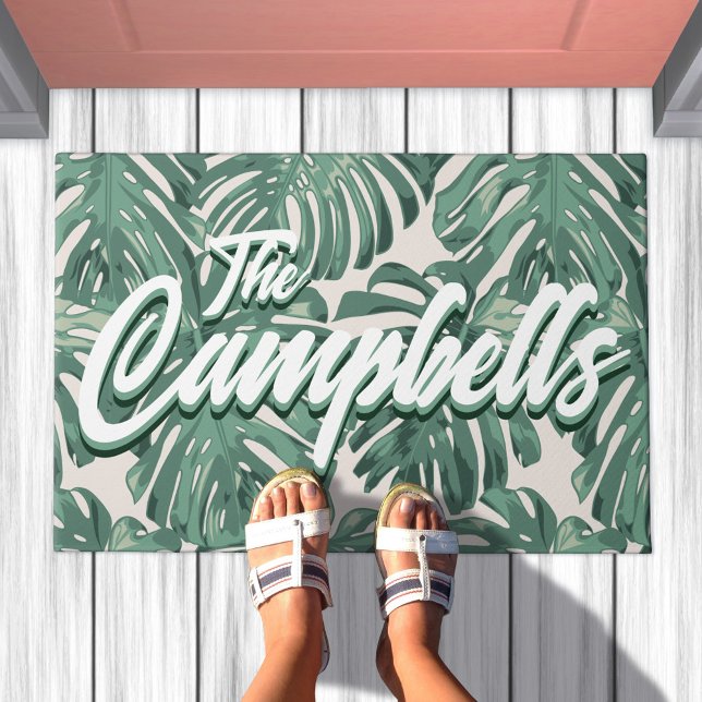 Green Tropical Leaves Script Last Name Doormat (Doormat with pattern of sage green tropical leaves. Overlaid is your family last name)
