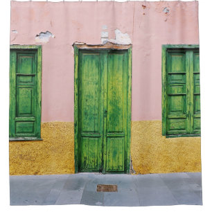 GREEN WOODEN DOOR ON WHITE CONCRETE WALL