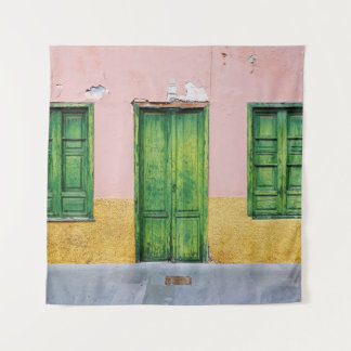 GREEN WOODEN DOOR ON WHITE CONCRETE WALL TAPESTRY