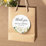 Greenery White Roses Floral Wedding Thank You Classic Round Sticker<br><div class="desc">Enhance the elegance of your wedding favors with these Greenery White Roses Floral Wedding Thank You Favor Stickers. Adorned with delicate white roses and lush greenery, these stickers exude a romantic and timeless charm. The customizable design allows you to add your names, wedding date, or a heartfelt message to express...</div>