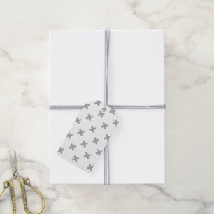 Grey cross stitches on white gift tags