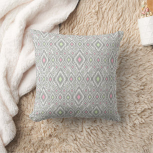 Grey, green, pink rhombuses on a white throw pillow
