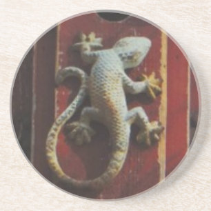grey lizard on worn wood coaster