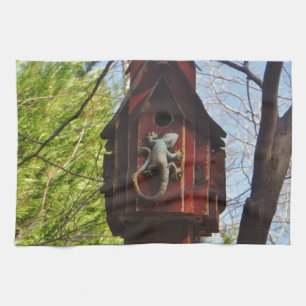 grey lizard on worn wood kitchen towel