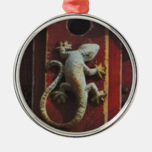 grey lizard on worn wood metal ornament