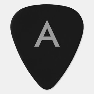 Grey on black, initials as letter. guitar pick