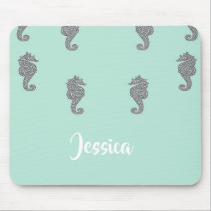 Grey seahorses on blue mouse pad