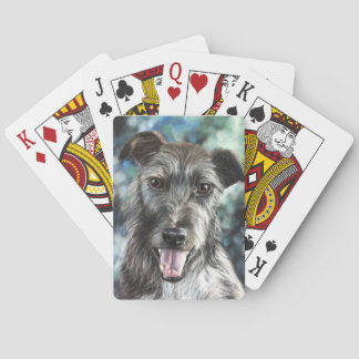 Grey terrier dog puppy playing cards