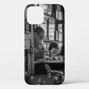 GREYSCALE PHOTO OF MAN SITTING WHILE READING NEWSP iPhone 12 CASE