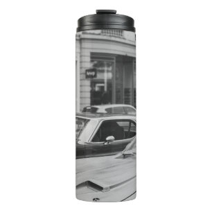 GREYSCALE PHOTOGRAPHY OF CARS ON ROAD BESIDE BUILD THERMAL TUMBLER