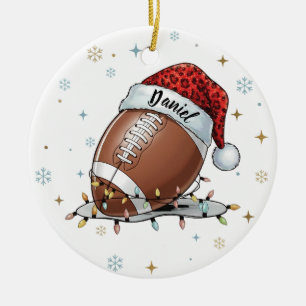 Gridiron Glow: Football with Santa Hat Ceramic Ornament