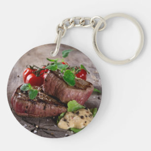 Grilled bbq steaks with fresh herbs and tomatoes keychain