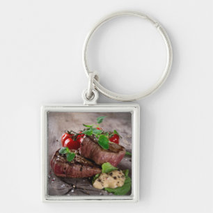 Grilled bbq steaks with fresh herbs and tomatoes keychain