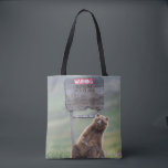 Grizzly Bear Plays With Sign Tote Bag<br><div class="desc">Grizzly bear scratches a roadside sign in Sable Pass,  Denali National Park,  Alaska</div>