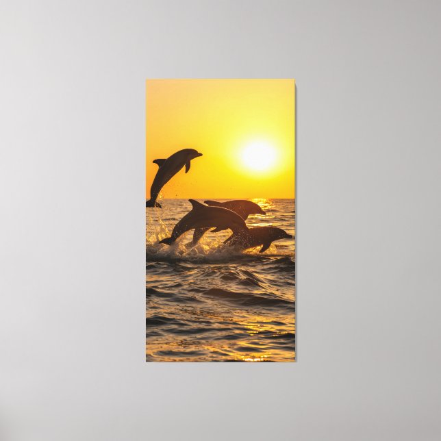group of dolphins happily leap out of the waves  canvas print (Front)