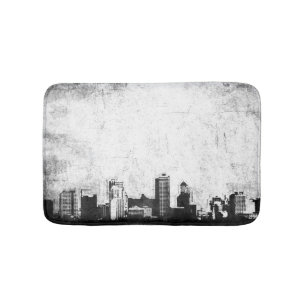 Grungy city background in black and white bath mat