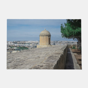 Gun turret on old city walls in Valletta, Malta Doormat