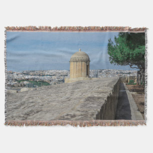 Gun turret on old city walls in Valletta, Malta Throw Blanket