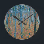Gustav Klimt Beech Tree Forest Grove Round Clock<br><div class="desc">This is based on classic nature painting artworks by Gustav Klimt, Beech Grove 1, 1902. The artwork portrays a dense forest of tall, slender birch trees, with pale trunks marked by dark, vertical lines. The foliage is depicted in shades of blue, green, and yellow, adding a sense of depth and...</div>