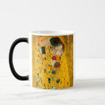 Gustav Klimt The Kiss Magic Mug<br><div class="desc">Magic Mug featuring Gustav Klimt’s oil painting with gold leaf The Kiss (1908). A man and woman,  wearing brilliant golden colours,  lovingly embrace and kiss in a field of flowers. A great gift for fans of Art Nouveau and Austrian art.</div>