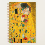 Gustav Klimt The Kiss Planner<br><div class="desc">Planner featuring Gustav Klimt’s oil painting with gold leaf The Kiss (1908). A man and woman, wearing brilliant golden colours, lovingly embrace and kiss in a field of flowers. A great gift for fans of Art Nouveau and Austrian art.</div>