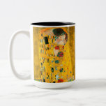 Gustav Klimt The Kiss Two-Tone Coffee Mug<br><div class="desc">Coffee Mug featuring Gustav Klimt’s oil painting with gold leaf The Kiss (1908). A man and woman,  wearing brilliant golden colours,  lovingly embrace and kiss in a field of flowers. A great gift for fans of Art Nouveau and Austrian art.</div>