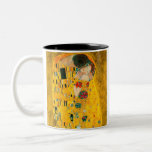 Gustav Klimt The Kiss Two-Tone Coffee Mug<br><div class="desc">Coffee Mug featuring Gustav Klimt’s oil painting with gold leaf The Kiss (1908). A man and woman,  wearing brilliant golden colours,  lovingly embrace and kiss in a field of flowers. A great gift for fans of Art Nouveau and Austrian art.</div>