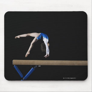 Gymnast (9-10) flipping on balance beam, side mouse pad