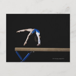 Gymnast (9-10) flipping on balance beam, side postcard