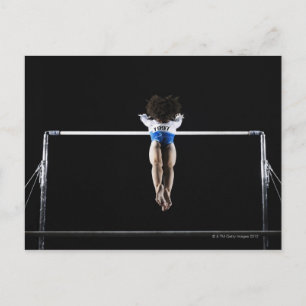 Gymnast (9-10) reaching for uneven bars postcard