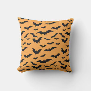 Halloween bats on orange background throw pillow