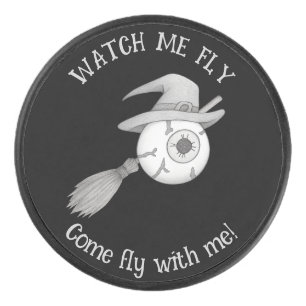 Halloween witch broom and scary eyeball hockey puck