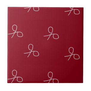 Hand drawn scissors on maroon red tile