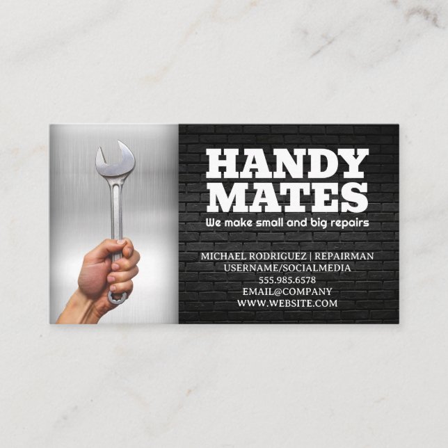 Hand Holding Wrench | Metal and Brick Business Card (Front)