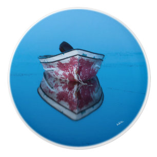 Handle of door, photograph of a boat on water ceramic knob
