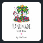 Handmade with Love Tropical Christmas Palm Tree Square Sticker<br><div class="desc">Handmade with Love product stickers with a seasonal holiday image. A tropical palm tree decorated in festive lights with a star on top. A giant red and white candy cane sticking out of the sand. Christmas presents under the tree. Whimsical and fun.</div>