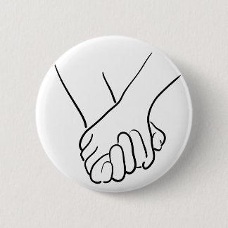 hands holding 2 inch round button