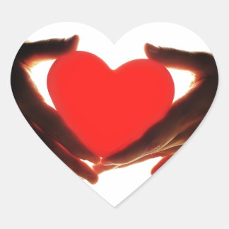 Hands holding heart sticker