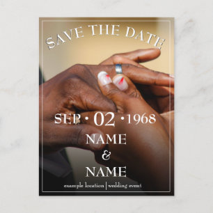 Hands of a coloured wedding couple pin on ring announcement postcard