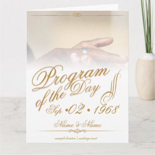 Hands of a coloured wedding couple pin on ring gol card