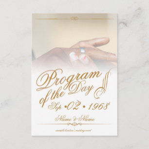 Hands of a coloured wedding couple pin on ring gol enclosure card