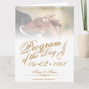 Hands of a coloured wedding couple pin on ring gol thank you card