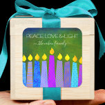 Hanukkah Blue Boho Candles Green Peace Love Light Square Sticker<br><div class="desc">“Peace, love & light.” A playful, modern, artsy illustration of boho pattern candles helps you usher in the holiday of Hanukkah. Assorted blue candles with colourful faux foil patterns overlay a rich, deep green textured background. Feel the warmth and joy of the holiday season whenever you use this stunning, colourful,...</div>