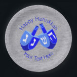 Hanukkah Dreidels Blue Festival of Lights Party Paper Plate<br><div class="desc">Set on a faux silver-look backing, two Hanukkah Dreidels in white and vivid blues set the mood for your Chanukah celebration. These Hanukkah party paper plates have two lines of bright blue text to be customized and personalized, from changing the holiday greeting to adding your name or date. Truly one-of-a-kind,...</div>