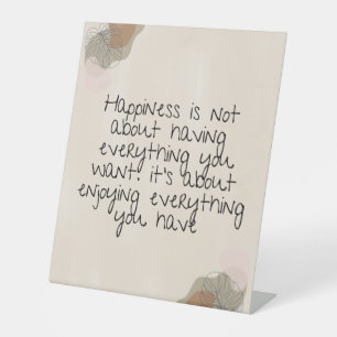 Happiness is not about having everything you want. pedestal sign