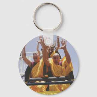 Happy buddhist monks on a roller coaster keychain