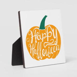 Happy Halloween lettering on carved pumpkin Plaque